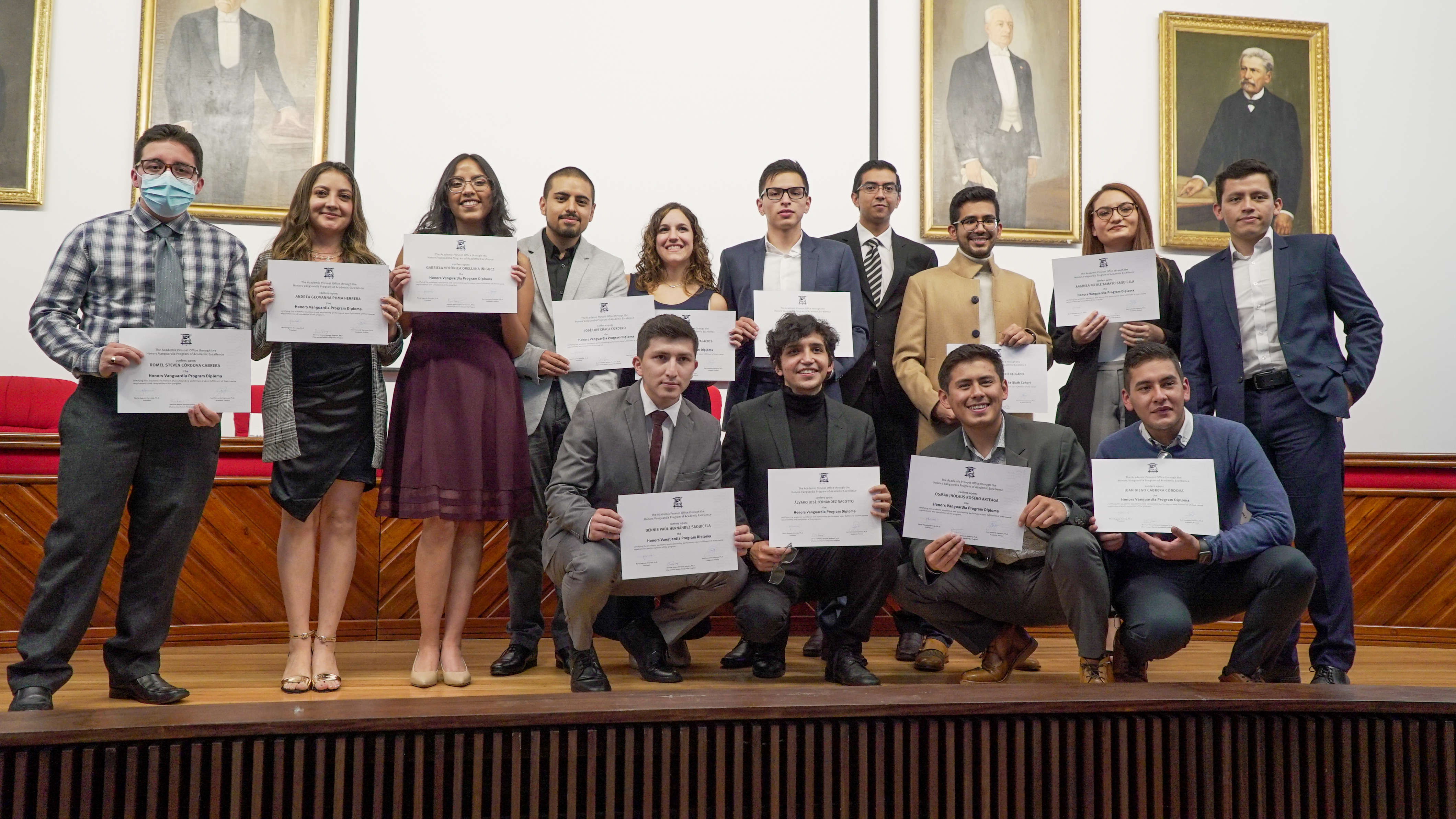 Vanguardia Honors Program graduates holding their diplomas at the University of Cuenca